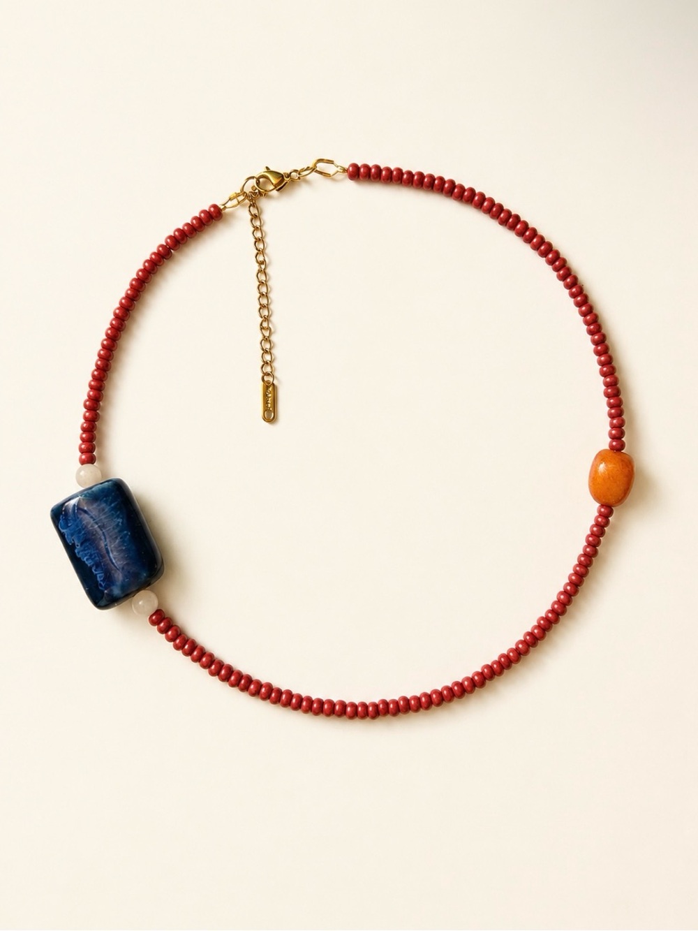 Red Beaded Necklace with Blue Focal Stone and Orange Accent